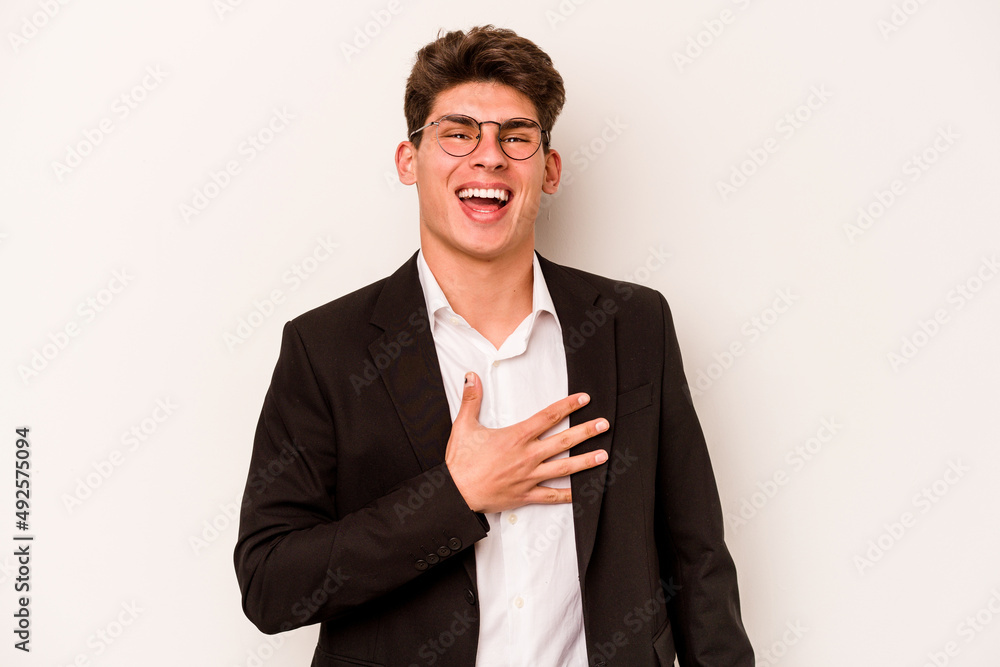 Young caucasian business man isolated on white background laughs out loudly keeping hand on chest. Young caucasian business man isolated on white background laughs out loudly keeping hand on chest.