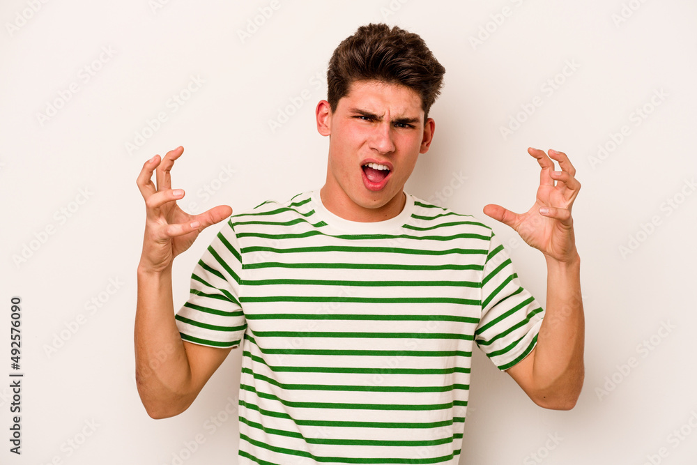 Young caucasian man isolated on white background screaming with rage. Young caucasian man isolated on white background screaming with rage.