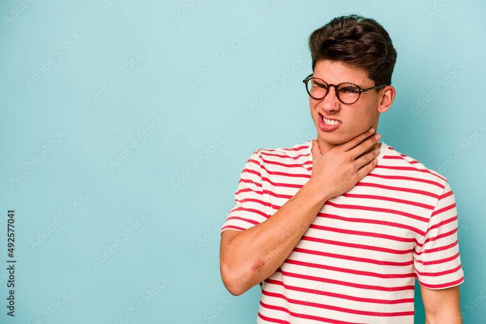 Young caucasian man isolated on blue background touching back of head, thinking and making a choice. Young caucasian man isolated on blue background touching back of head, thinking and making a choice.