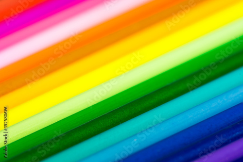 Rainbow multicolor pattern. Refills of a colored pens close-up. Blurred and defocused background.