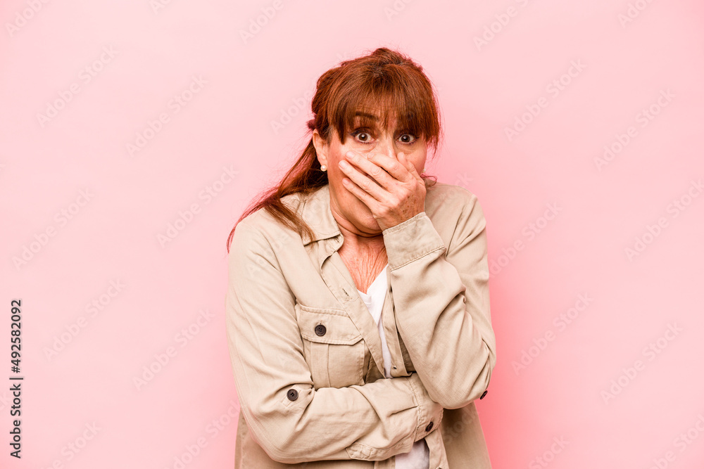 Middle age caucasian woman isolated on pink background scared and afraid. Middle age caucasian woman isolated on pink background scared and afraid.