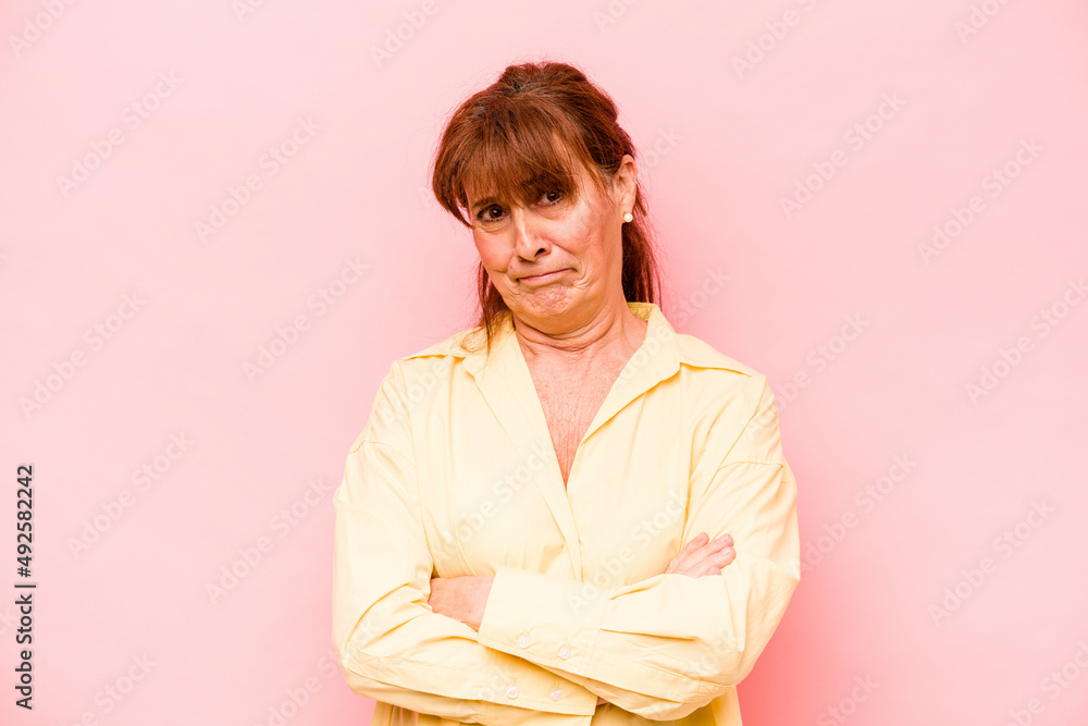 Middle age caucasian woman isolated on pink background unhappy looking in camera with sarcastic expression. Middle age caucasian woman isolated on pink background unhappy looking in camera with sarcastic expression.