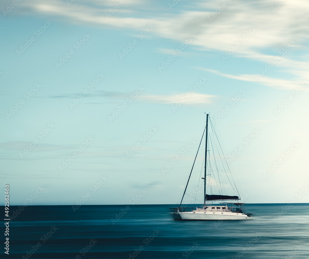 Beautiful minimalist panning shot of a boat in the ocean