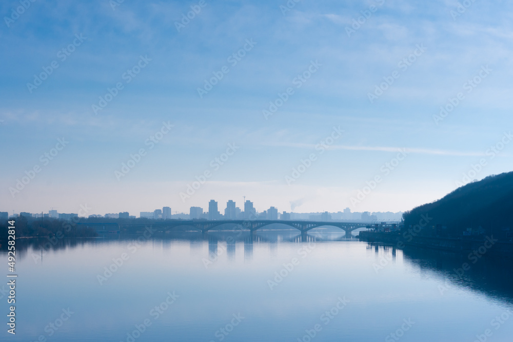 Fototapeta premium Evening city landscape of the capital of Ukraine from the bridge on Dnipro river