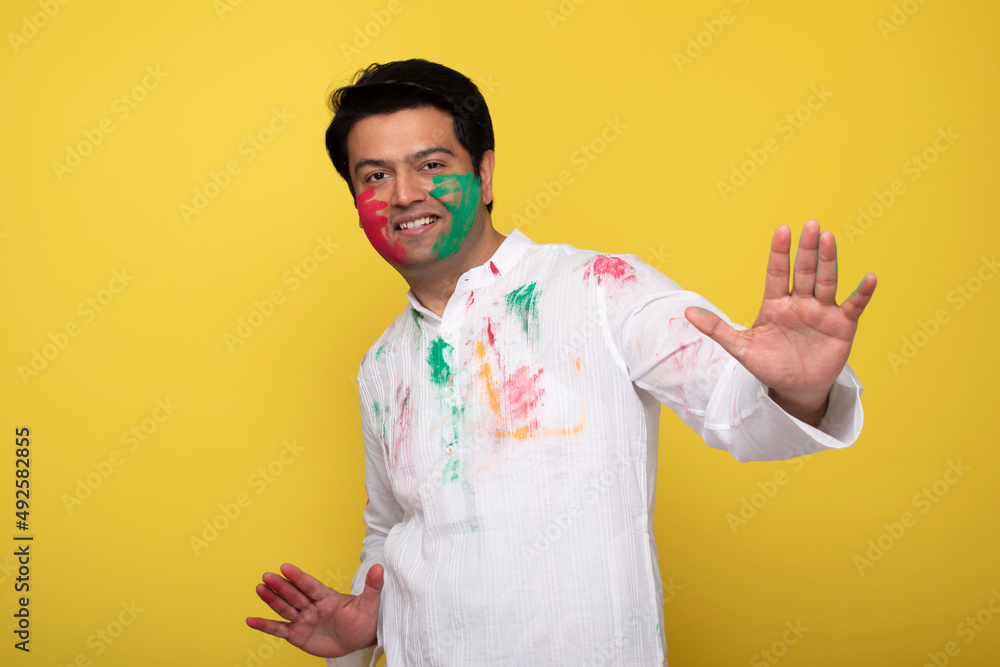 Young man celebrating holi Young man celebrating holi