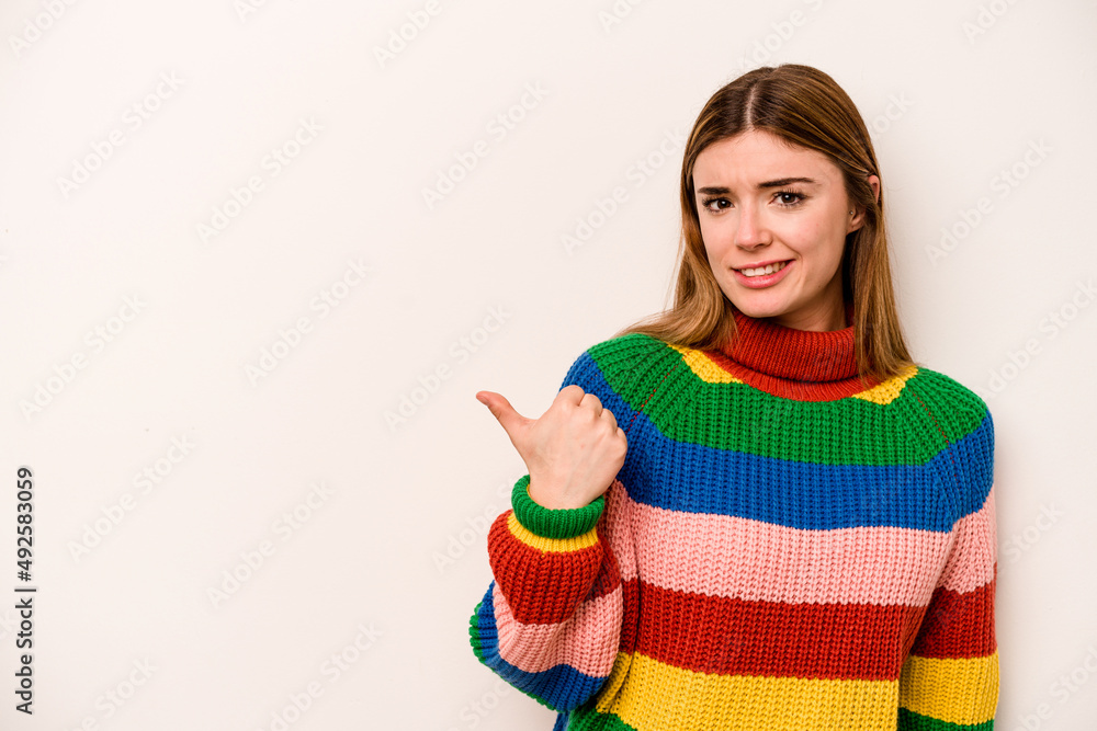 Young caucasian woman isolated on white background shocked pointing with index fingers to a copy space. Young caucasian woman isolated on white background shocked pointing with index fingers to a copy space.
