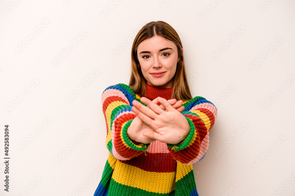 Young caucasian woman isolated on white background standing with outstretched hand showing stop sign, preventing you. Young caucasian woman isolated on white background standing with outstretched hand showing stop sign, preventing you.