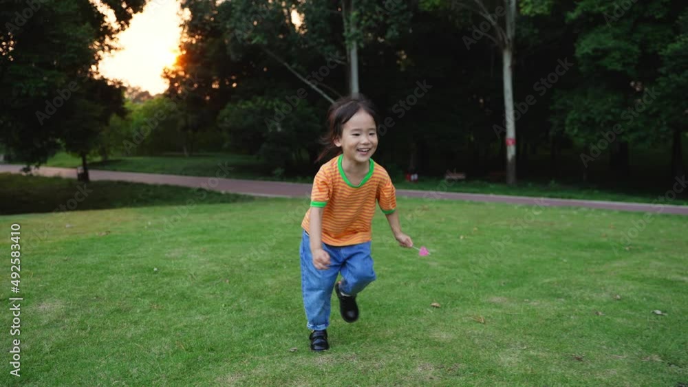 Lovely little girl running on grass happily to her mother Lovely little girl running on grass happily to her mother