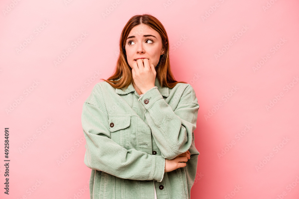 Young caucasian woman isolated on pink background biting fingernails, nervous and very anxious. Young caucasian woman isolated on pink background biting fingernails, nervous and very anxious.