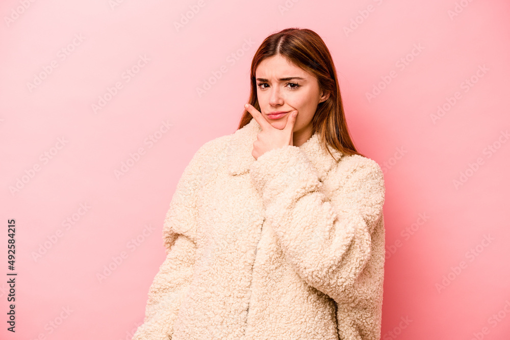 Young caucasian woman isolated on pink background contemplating, planning a strategy, thinking about the way of a business. Young caucasian woman isolated on pink background contemplating, planning a strategy, thinking about the way of a business.