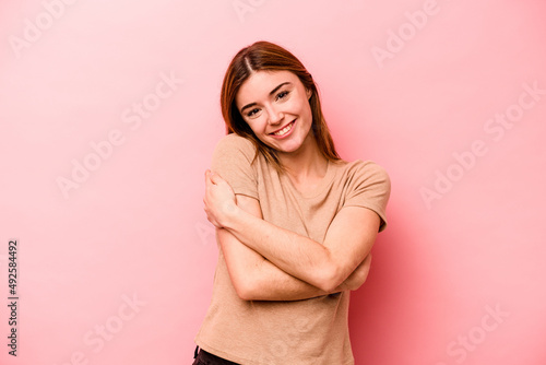 Young caucasian woman isolated on pink background laughing and having fun.