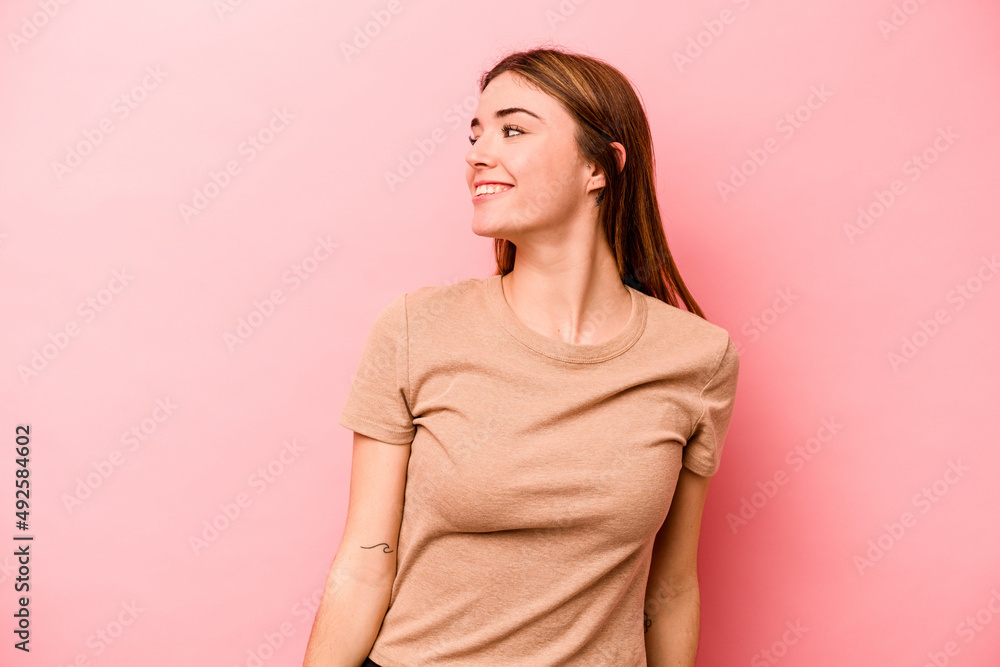 Young caucasian woman isolated on pink background relaxed and happy laughing, neck stretched showing teeth. Young caucasian woman isolated on pink background relaxed and happy laughing, neck stretched showing teeth.