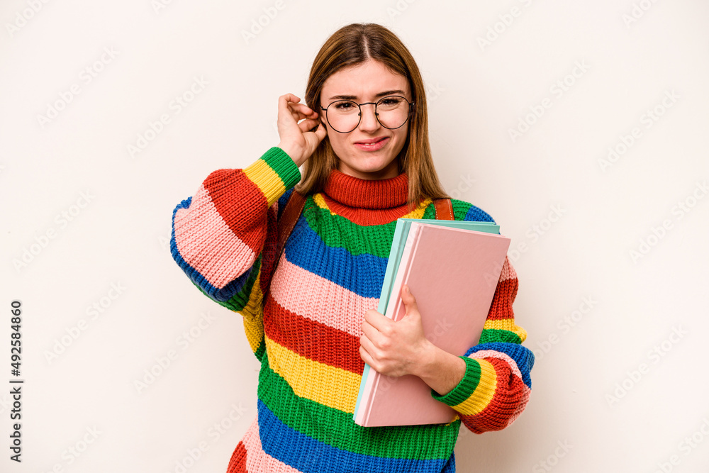 Young student caucasian woman isolated on white background covering ears with hands. Young student caucasian woman isolated on white background covering ears with hands.