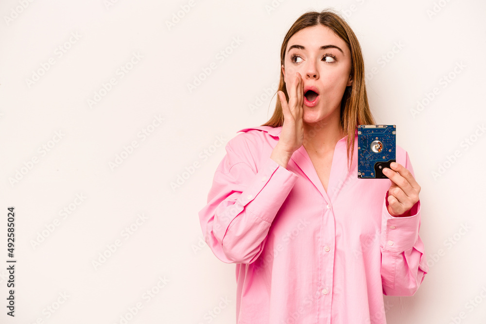 Young informatic caucasian woman isolated on white background is saying a secret hot braking news and looking aside Young informatic caucasian woman isolated on white background is saying a secret hot braking news and looking aside
