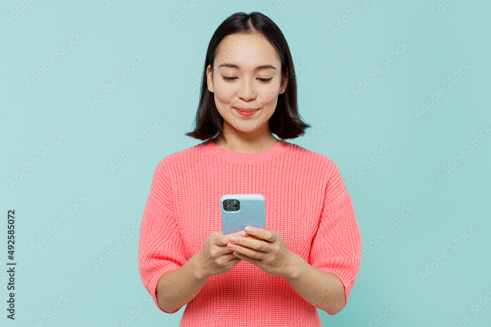 Young smiling happy woman of Asian ethnicity 20s wearing pink sweater ...