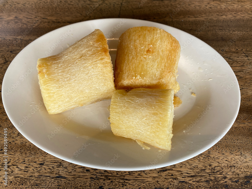 Fried cassava slices on a white plate. Focus selected