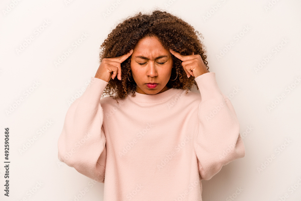 Young African American woman isolated on white background focused on a task, keeping forefingers pointing head. Young African American woman isolated on white background focused on a task, keeping forefingers pointing head.