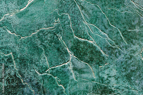 background surface texture in various shades of green covered with irregular lines