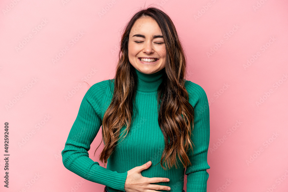 Young caucasian woman isolated on pink background touches tummy, smiles gently, eating and satisfaction concept. Young caucasian woman isolated on pink background touches tummy, smiles gently, eating and satisfaction concept.