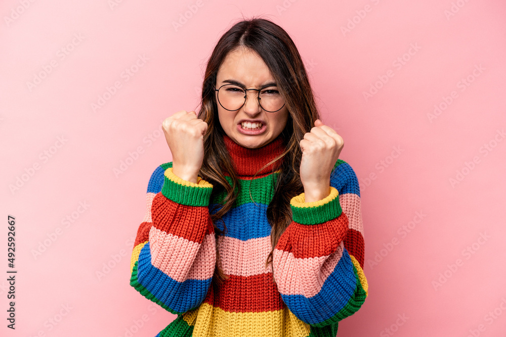 Young caucasian woman isolated on pink background upset screaming with tense hands. Young caucasian woman isolated on pink background upset screaming with tense hands.