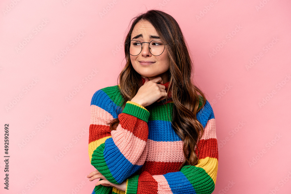 Young caucasian woman isolated on pink background suffers pain in throat due a virus or infection. Young caucasian woman isolated on pink background suffers pain in throat due a virus or infection.