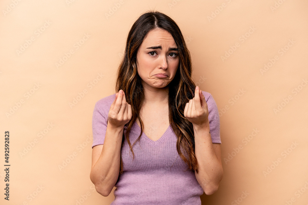 Young caucasian woman isolated on beige background showing that she has no money. Young caucasian woman isolated on beige background showing that she has no money.