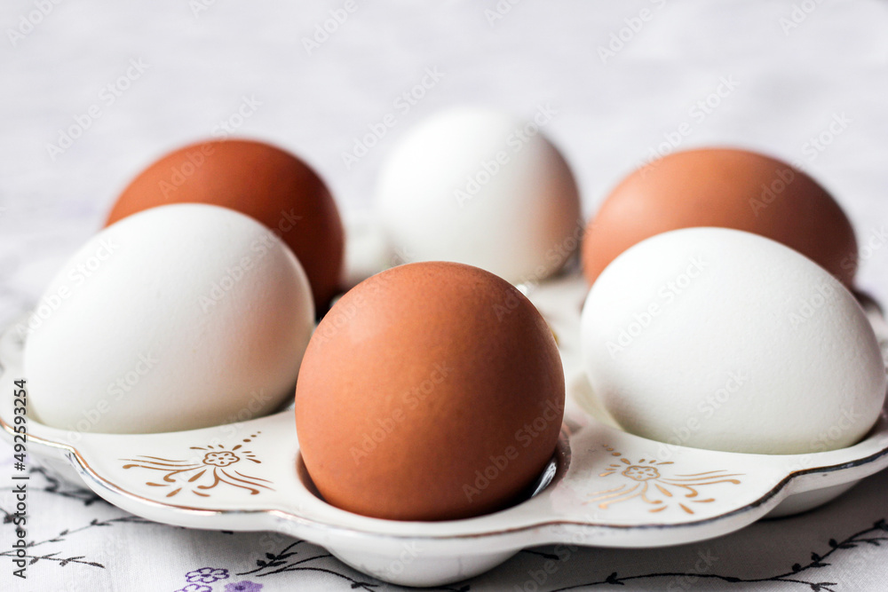 White and brown eggs on a special plate. natural color.