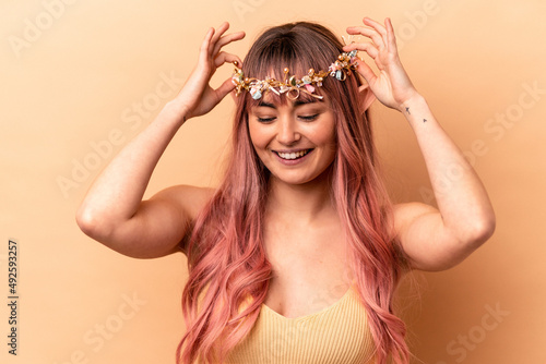 Young elf woman with pink hair isolated on beige background © Asier