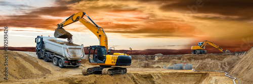 earth mover and excavator at work in construction site