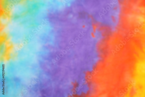 Blurred abstract tie dye multicolor fabric cloth pattern texture for background or groovy wedding card, sale flyer, 60s, 70s poster, kid tie-dye diy backdrop. Modern Watercolor Wet Brush Fabrics Art © Aleksandra Konoplya