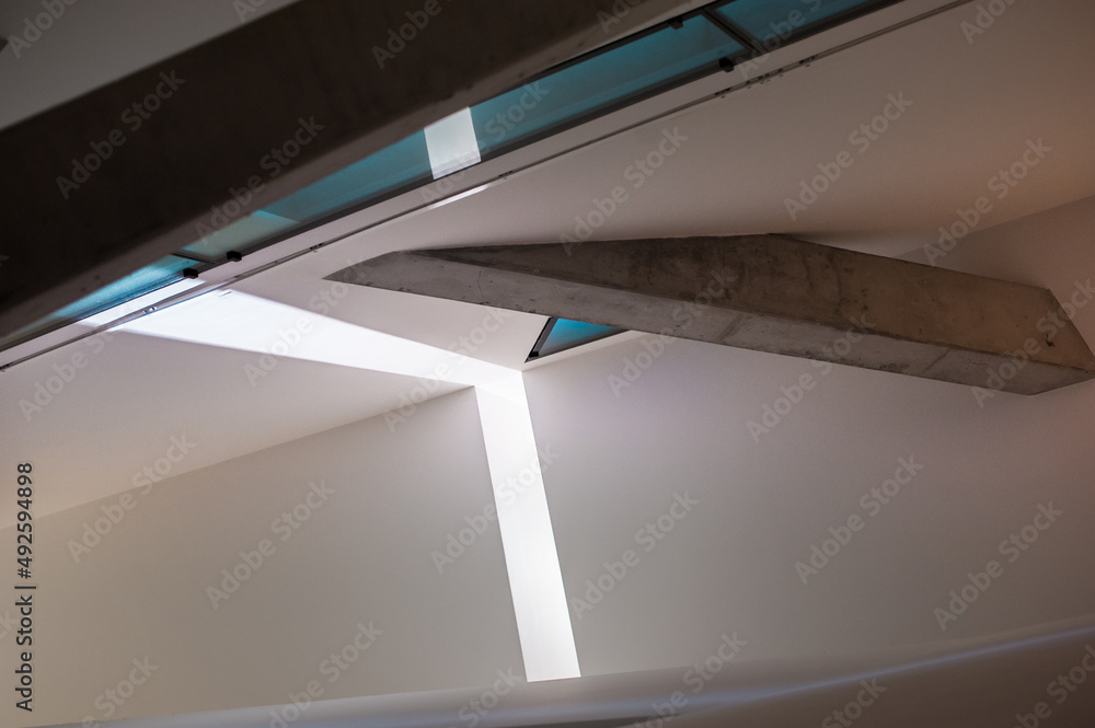 Fototapeta premium interior of a building of modern contemporary architecture with reinforced concrete beveled beams and roof slatted windows