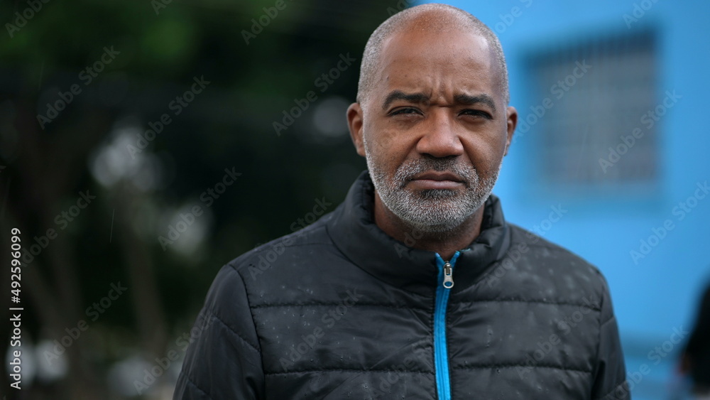 A senior black man portrait face with serious expression looking at camera A senior black man portrait face with serious expression looking at camera