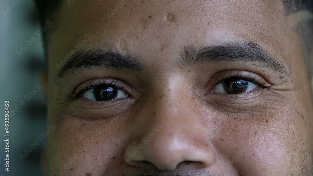 A hispanic black man eyes close-up face smiling looking at camera A hispanic black man eyes close-up face smiling looking at camera