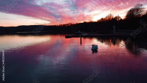 Aerial dron view of lake, water and silhouette of trees during sunset. Evening nature, beautiful landscape. FullHD footage
