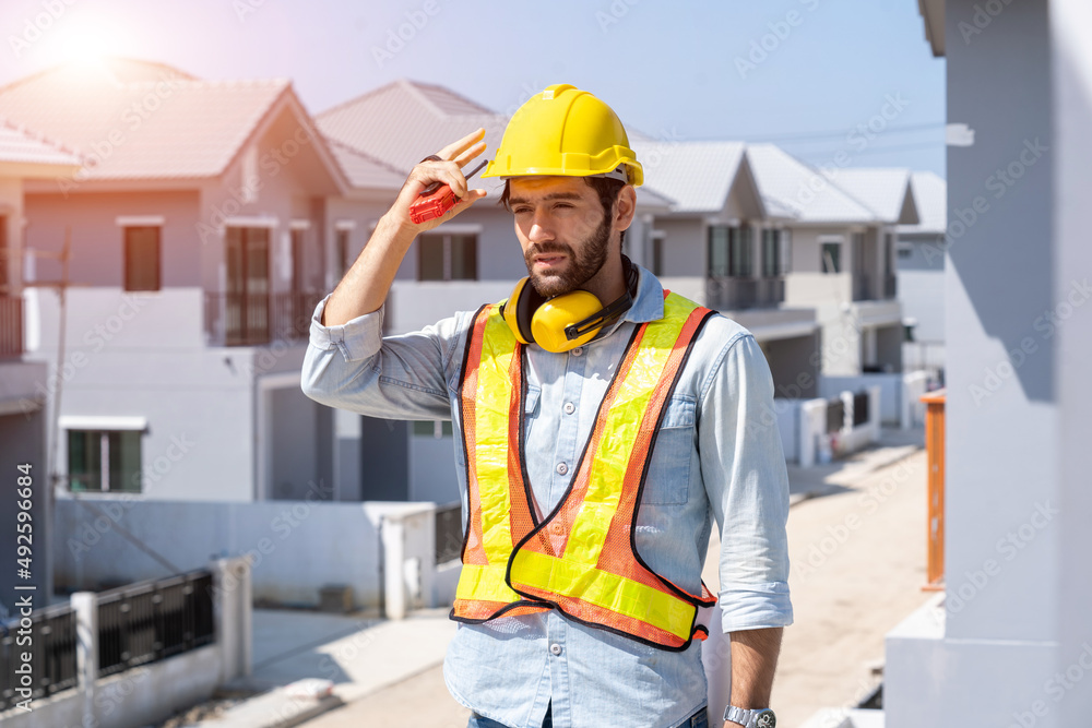 Construction engineering worker talking on radio,Construction engineer use radio communication at construction site. Construction engineering worker talking on radio,Construction engineer use radio communication at construction site.