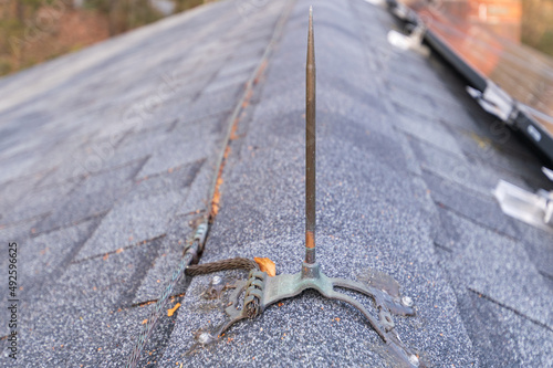 Slika na platnu Close up of  lighting rod mounted on a residential roof to ground the structure
