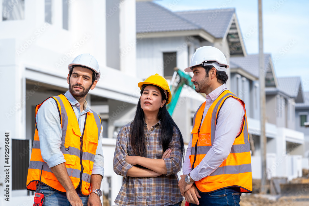 Engineer and architect discussing building plan at construction site,Group of builders having conversation about building plan,business,building,industry,people concept. Engineer and architect discussing building plan at construction site,Group of builders having conversation about building plan,business,building,industry,people concept.