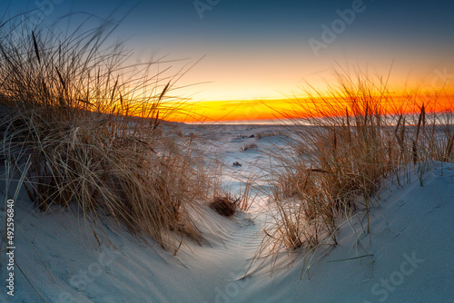Fototapeta Naklejka Na Ścianę i Meble -  Beautiful scenery of the Baltic Sea beach at sunset, Slowinski National Park, Leba. Poland