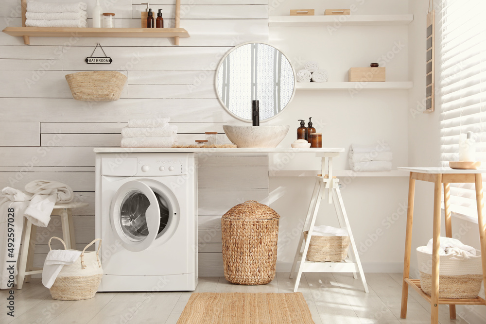 Stylish bathroom interior with modern washing machine Stylish bathroom interior with modern washing machine