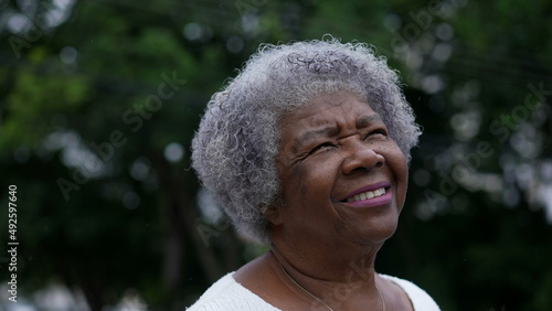 Portrait of an older woman face looking up at sky with HOPE and FAITH