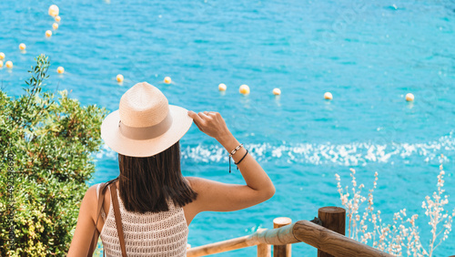 Concept of a young woman on vacation in front of the sea.