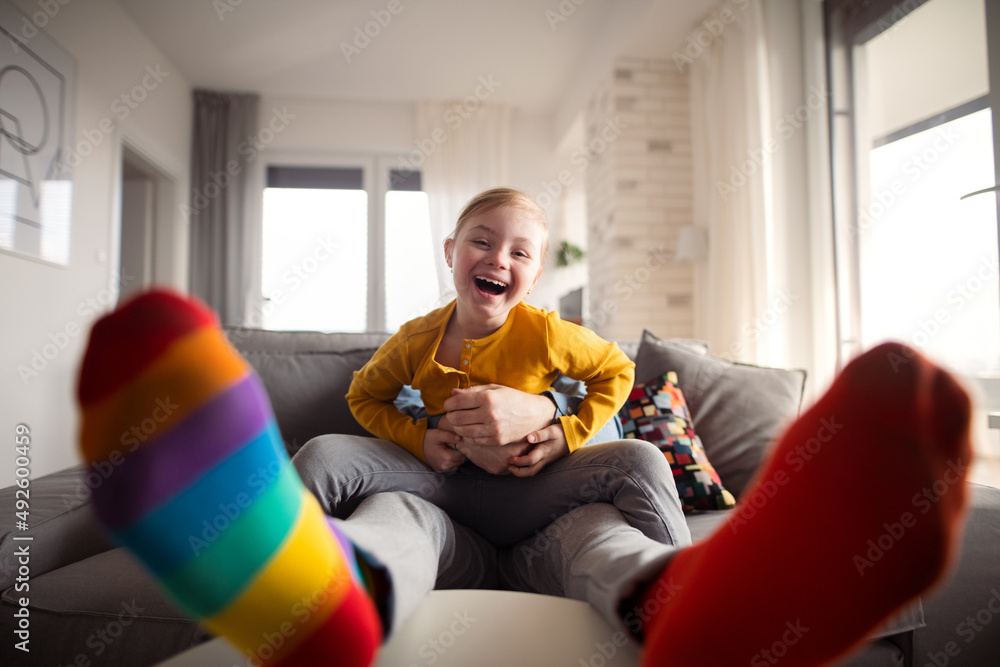 Εκτύπωση καμβά Cheerful little girl with Down syndrome having fun with her father at home