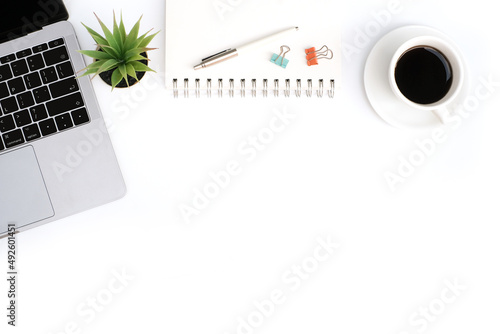 Top view business finance office and marketing concept on white table desk with keyboard computer and graph document, coffee cup and stationery, flat lay with copy space