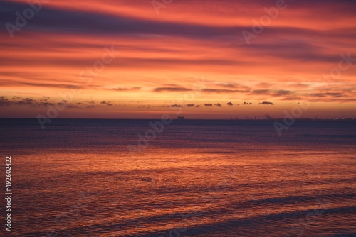 Abstract colorful sea background. Sea waves and beautiful colorful sky at sunrise.