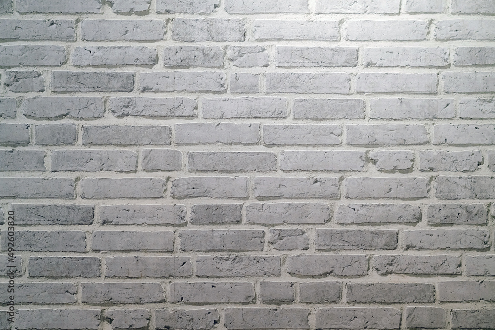 White brick wall texture background made by pattern paper. Wall texture background flooring rock stone old pattern clean concrete grid uneven bricks design stack. Background for the wall in LOFT style White brick wall texture background made by pattern paper. Wall texture background flooring rock stone old pattern clean concrete grid uneven bricks design stack. Background for the wall in LOFT style