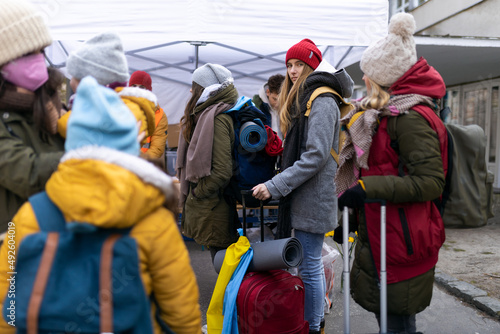 Ukrainian immigrants crossing border and getting donations from volunteers, Ukrainian war concept.