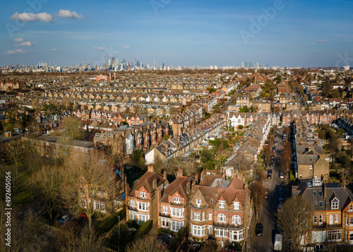 Aerial view of city of London skyline with terraced house rooftops of south west London in foreground  photo