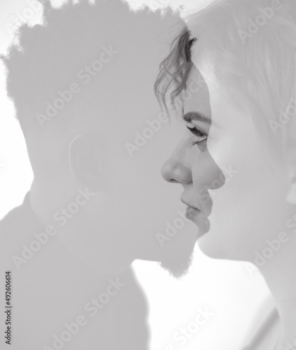 Portrait with multi exposure artistic effect of young african man and caucasian woman.