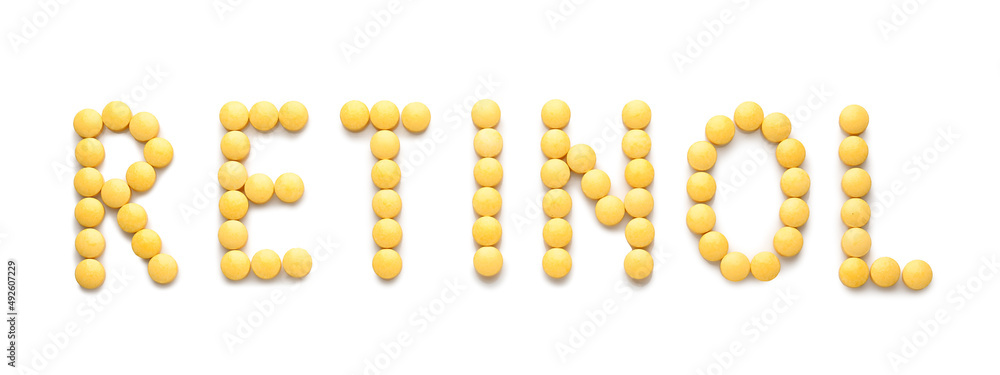 Word RETINOL made of yellow pills on white background Word RETINOL made of yellow pills on white background