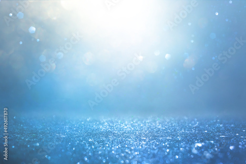 background of abstract blue and silver glitter lights. defocused